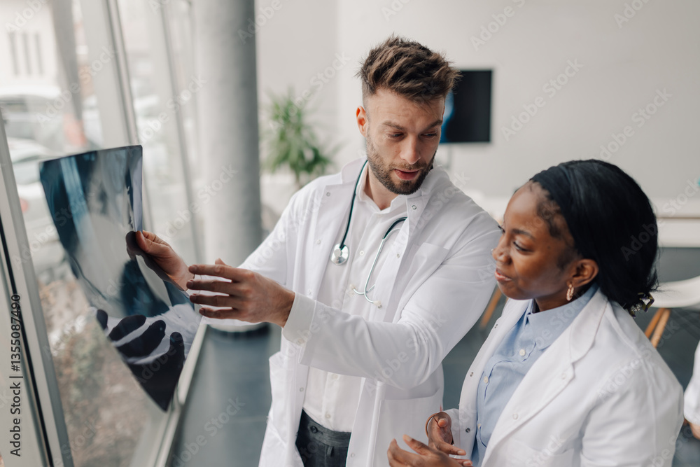 Fototapeta premium Doctors examining x ray of patient in hospital or clinic