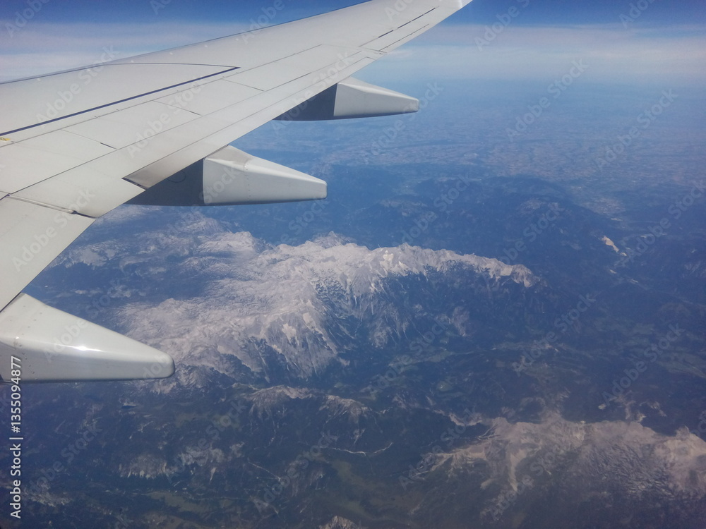 Fototapeta premium Breathtaking aerial view of mountain ranges captured during a clear daytime flight