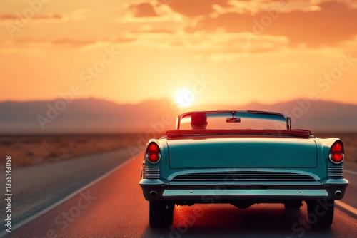 Fototapeta Naklejka Na Ścianę i Meble -  Classic convertible car driving into the sunset on desert highway