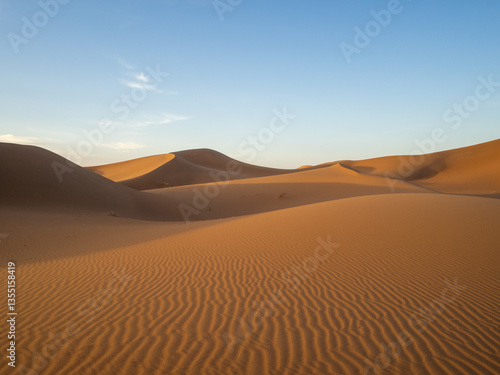 Sun and shadow over Erg Chegaga sand dunes, Morocco