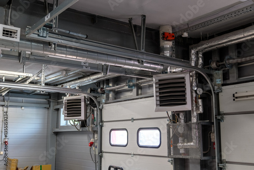 Obraz na płótnie Air heating system for industrial premises, new technologies. pressure regulators and manometers with a system of radiators at the gate w salonie