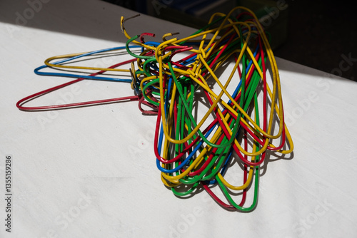 A bunch of colorful metal clothes hangers