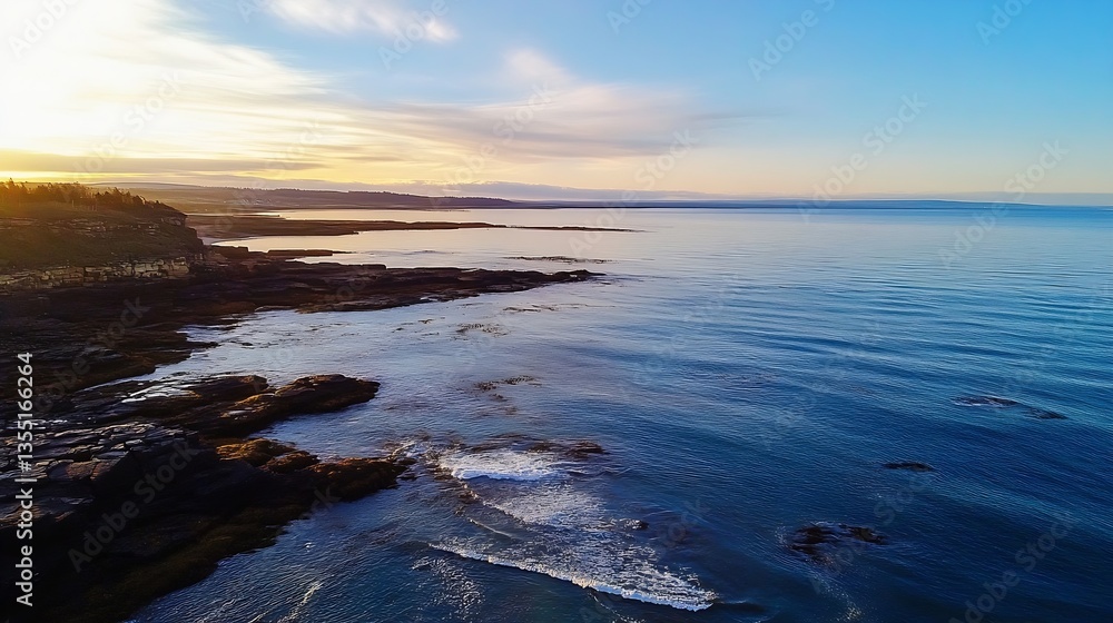 Obraz premium Breathtaking aerial view of a serene ocean landscape at sunset with calm water and rocky shorelines : Generative AI