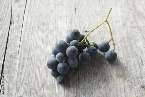 Dark Grapes on a Rustic Wooden Table
