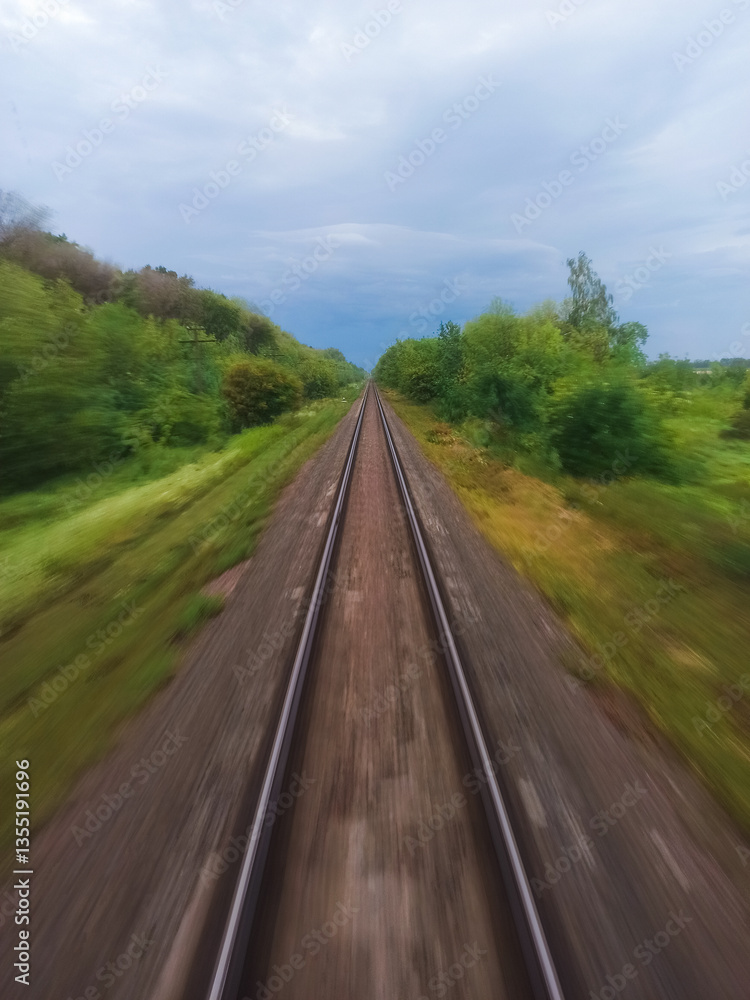 Obraz premium View from the train window on the rails going into the distance
