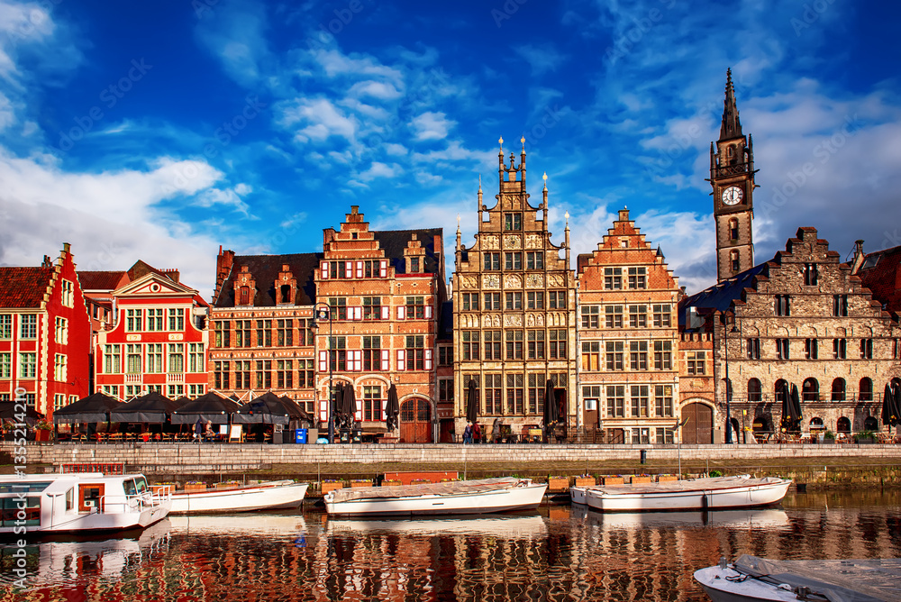 Obraz premium Ghent city historical center, tourists boats and colorful buildings on Leie river bank, Belgium