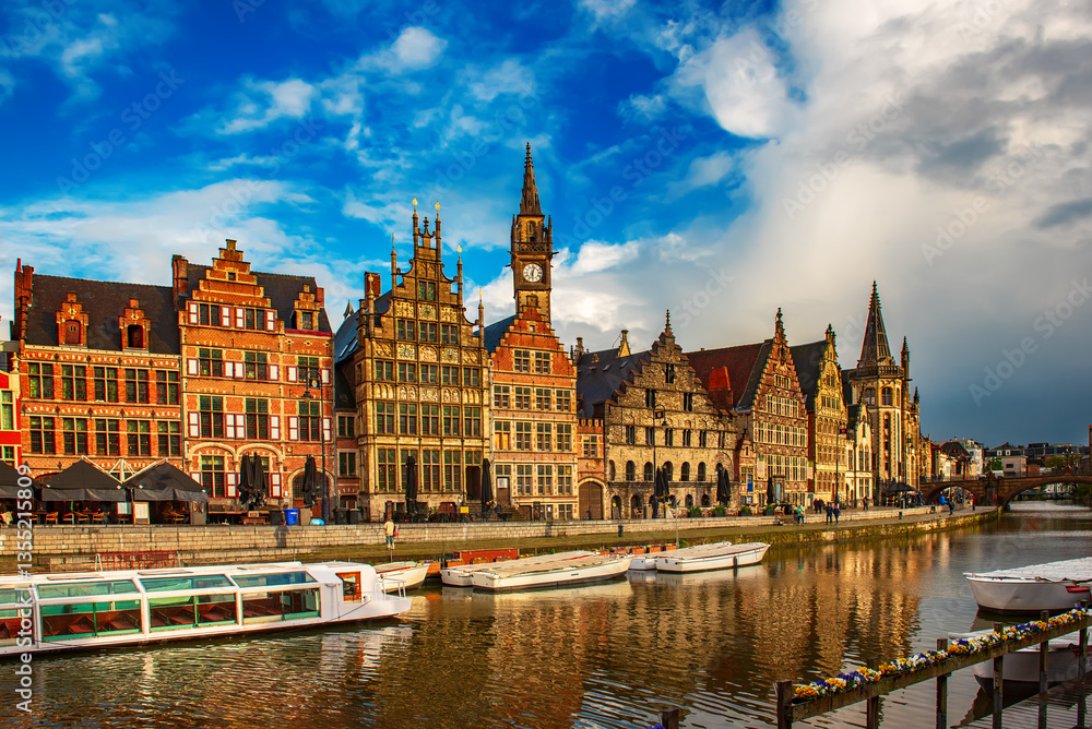 Obraz premium Ghent city historical center, tourists boats and colorful buildings on Leie river bank, Belgium