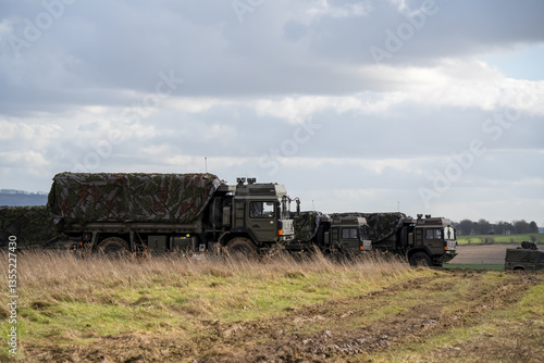 Obraz na płótnie several British army MAN SV 4x4 utility truck on a military exercise w salonie
