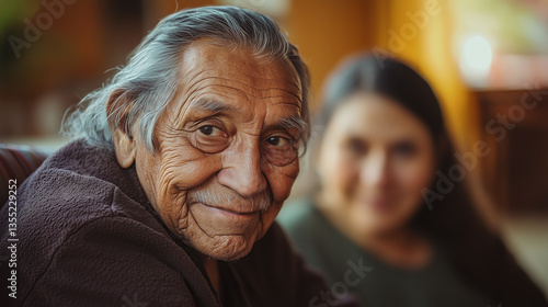 Smiling senior Native American Indian man, younger woman in the background