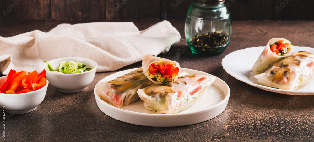 Vegetarian spring rolls with cucumber, pepper and fried mushrooms on a plate web banner