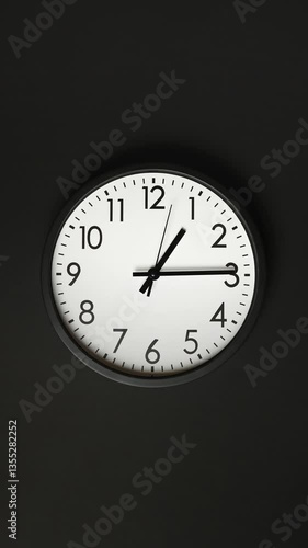 Black and white clock face. Time ticking on classic wall clock. Clock face on back background. Timelapse. Time concept. Wall clock show running time. Vertical video. Close-up in 4K, UHD