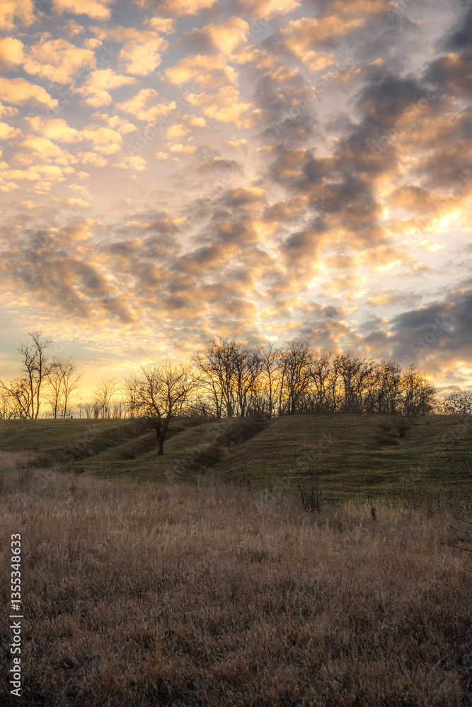 Landscape photo with beautiful sunset and clouds on the sky , field and trees , spring evening in the woodlands ,sun lights , beautiful nature Landscape photo with beautiful sunset and clouds on the sky , field and trees , spring evening in the woodlands ,sun lights , beautiful nature