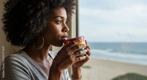 Woman Contemplating Ocean View While Enjoying Coffee