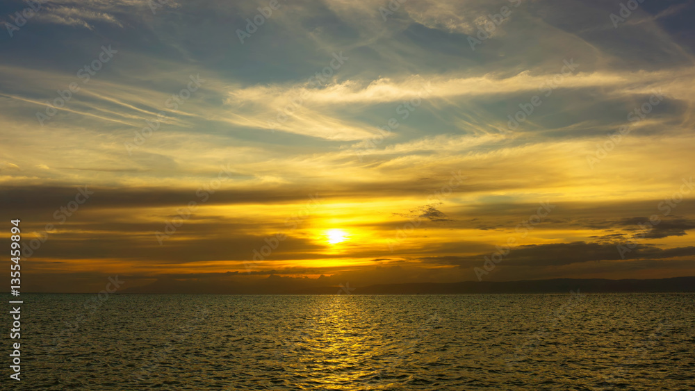 Fototapeta premium Stunning sunset over calm ocean waters
