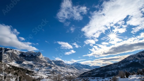 Stunning panoramic view of a snowcovered mountain range under a clear blue sky with clouds : Generative AI