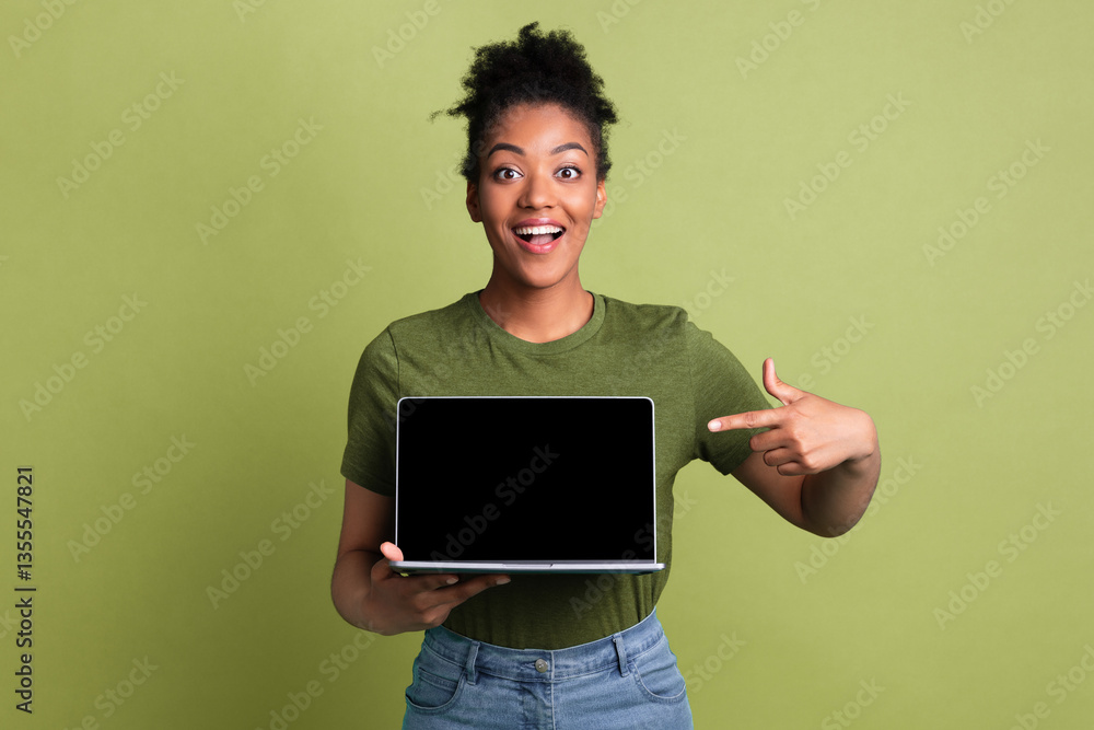 Excited african girl presenting laptop with black blank screen for mock up, isolated on green studio wall, empty space Excited african girl presenting laptop with black blank screen for mock up, isolated on green studio wall, empty space