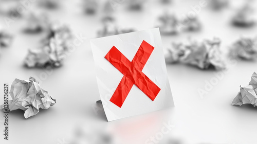 Obraz na płótnie Crumpled paper with exaggerated claims and red X mark on white desk, symbolizing false advertising and deceptive marketing practices. Concept of truth in advertising and consumer protection. w salonie