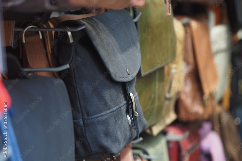 Handcrafted bags displayed in a local market during daytime Handcrafted bags displayed in a local market during daytime