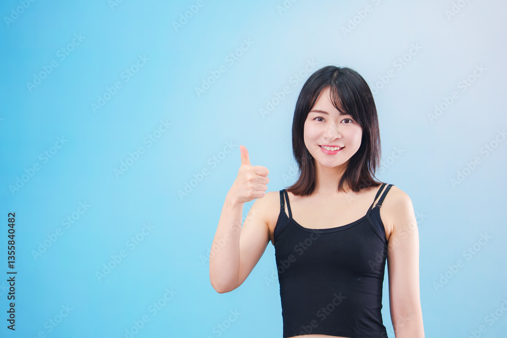 スポーツをする若い女性(水色背景) スポーツをする若い女性(水色背景)