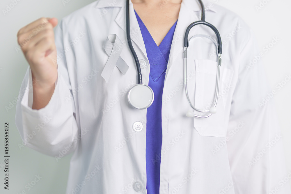 Brain Cancer Awareness May month, Doctor with grey color Ribbon for supporting life people. Healthcare and World cancer day concept Brain Cancer Awareness May month, Doctor with grey color Ribbon for supporting life people. Healthcare and World cancer day concept