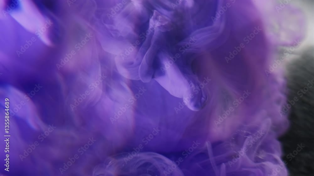 Puff paint. Defocused stream. Violet ink spray shoot smoke dissolving in mystical liquid. Art pouring swirl explosion abstract background. Puff paint. Defocused stream. Violet ink spray shoot smoke dissolving in mystical liquid. Art pouring swirl explosion abstract background.