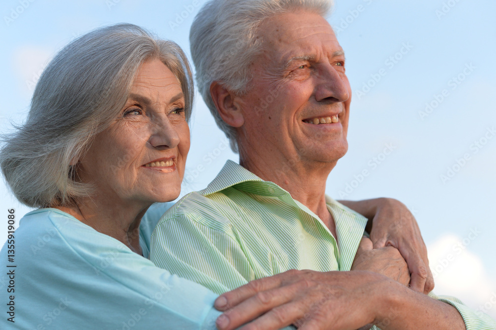 Loving elderly couple embracing outdoors