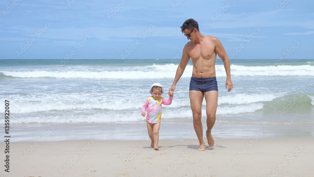 Athletic man runs out of water leading little girl in panama Athletic man runs out of water leading little girl in panama