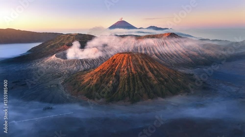 Aerial view flying to mount Bromo at sunrise, active volcano above sea of clouds, Java, Indonesia 
