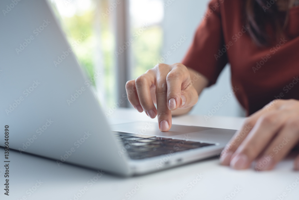 Woman working on laptop computer at home office. Business woman typing on notebook computer, surfing the net, searching the information, online working at home, closeup Woman working on laptop computer at home office. Business woman typing on notebook computer, surfing the net, searching the information, online working at home, closeup