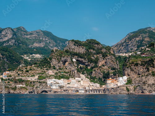 Scenic panorama of Atrani village on Amalfi Coast, Italy - Mediterranean white houses built on rocky cliffs with turquoise sea view