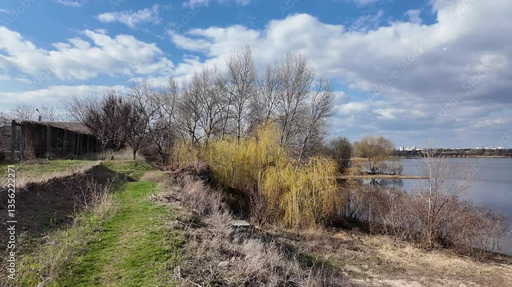 spring nature. walk in spring nature. path along the river in spring. hiking near the river. beautiful sky and lake. slow motion video. spring nature. walk in spring nature. path along the river in spring. hiking near the river. beautiful sky and lake. slow motion video.