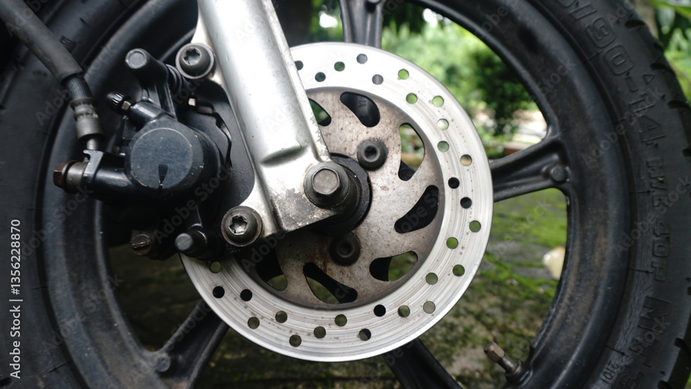 Motorcycle disc brake of front wheel and others details of brake caliper, rotor, rim, tire, and suspension Motorcycle disc brake of front wheel and others details of brake caliper, rotor, rim, tire, and suspension