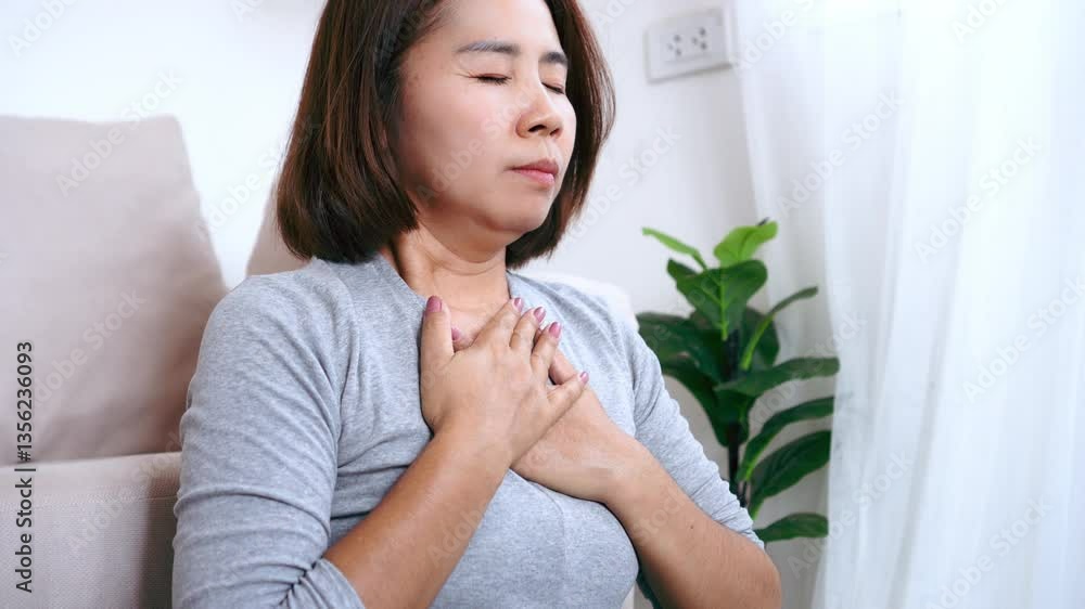 asian woman practicing deep breathing exercises after facing panic attack, trying to calm her mind and body, reduce stress, and manage anxiety for better emotional wellbeing asian woman practicing deep breathing exercises after facing panic attack, trying to calm her mind and body, reduce stress, and manage anxiety for better emotional wellbeing
