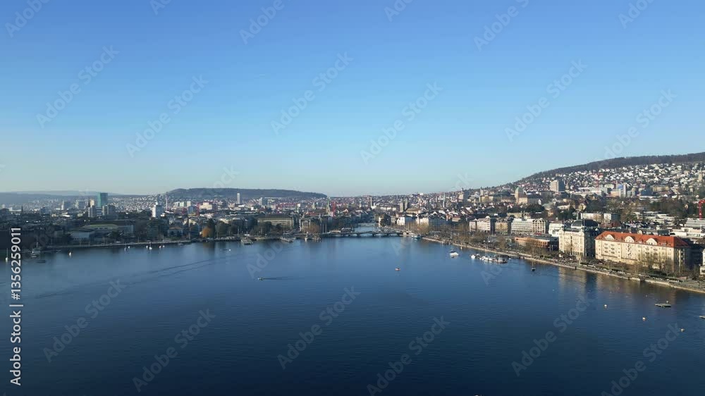 Aerial: Lake Zurich and Quay Bridge with cityscape and blue sky during the day in Zurich, canton of Zurich, Switzerland, establishing drone shot Aerial: Lake Zurich and Quay Bridge with cityscape and blue sky during the day in Zurich, canton of Zurich, Switzerland, establishing drone shot