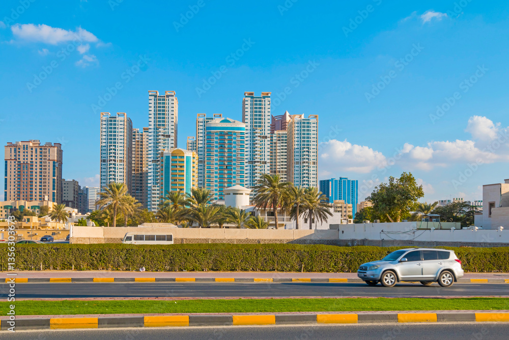 Scenic view of Sharjah’s skyline with modern skyscrapers rising against a clear sky. The cityscape showcases contemporary architecture, reflecting the dynamic growth of the urban landscape.