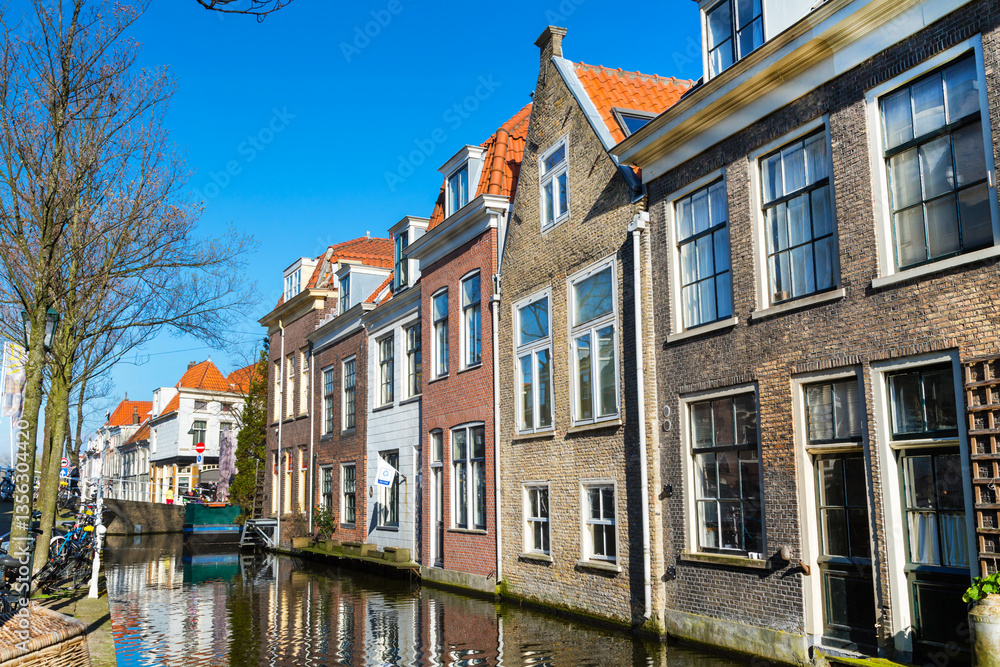 Fototapeta premium houses and canal in Delft, Holland at sunset