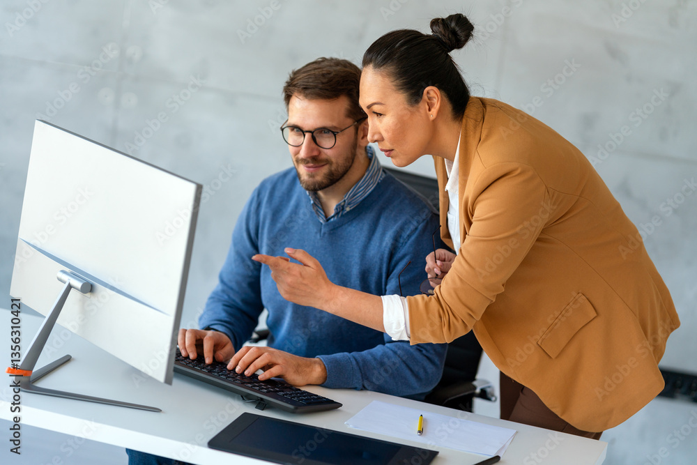Happy businesspeople laughing while collaborating on a new project in an office. Happy businesspeople laughing while collaborating on a new project in an office.