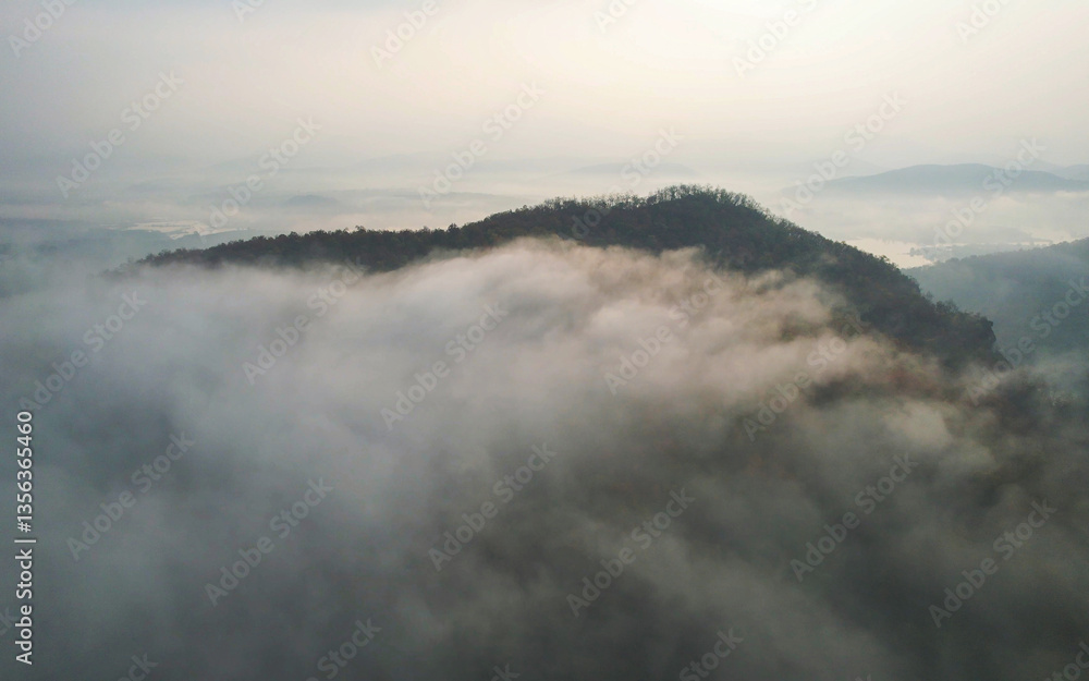 Aerial view landscape of fog flowing on mountains in the morning by drone Aerial view landscape of fog flowing on mountains in the morning by drone