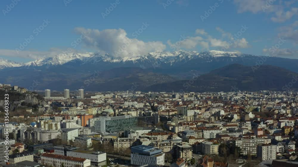 Aerial shot of the city of Grenoble surrounded by snow-capped mountains in winter, in France Aerial shot of the city of Grenoble surrounded by snow-capped mountains in winter, in France
