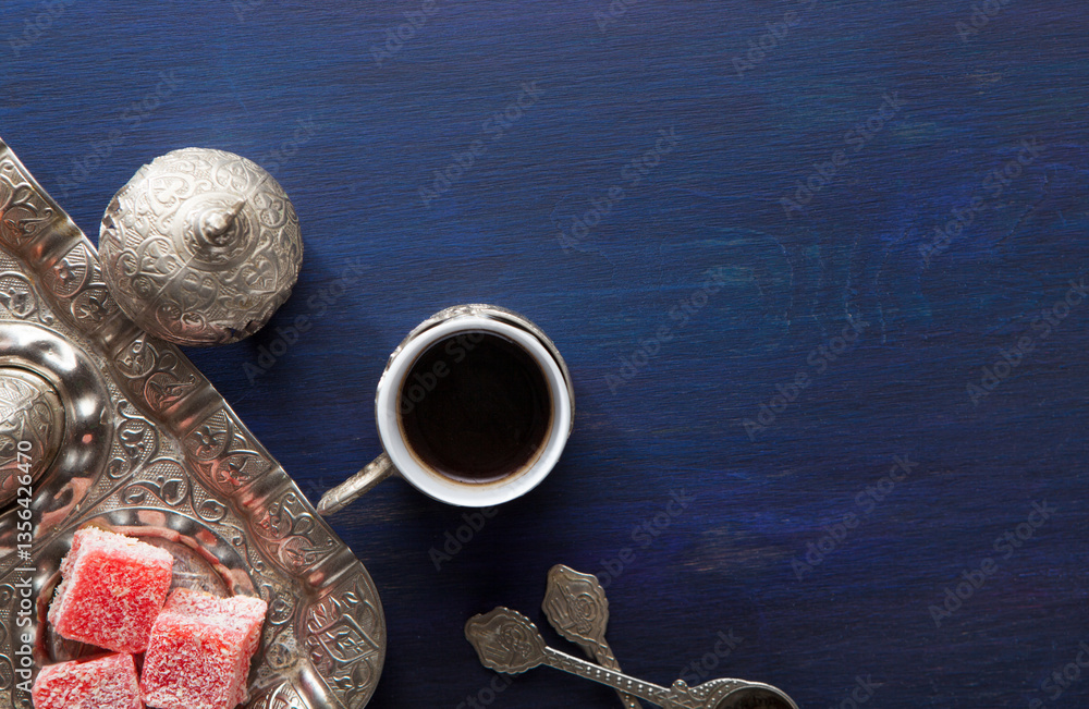 Traditional turkish coffee and turkish delight on dark blue wooden table. Top view
