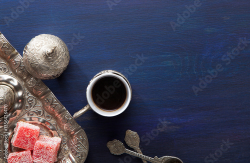 Obraz na płótnie Traditional turkish coffee and turkish delight on dark blue wooden table. Top view w salonie