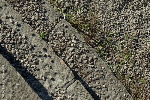 Rough Stone Steps with Gravel and Green Weeds. Natural Texture Background