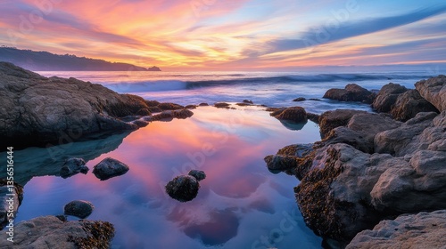 Fototapeta Naklejka Na Ścianę i Meble -  Beautiful sunset reflects over ocean tide pools and coastal rocks