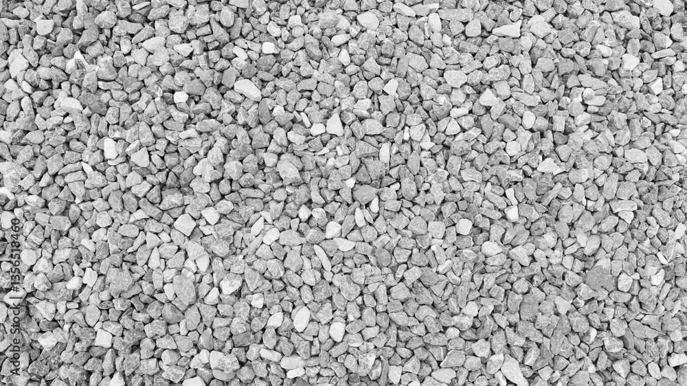 close-up view of crushed gray gravel, showcasing a rough and natural stone texture ideal for backgrounds, construction landscaping and industrial design elements. close-up view of crushed gray gravel, showcasing a rough and natural stone texture ideal for backgrounds, construction landscaping and industrial design elements.