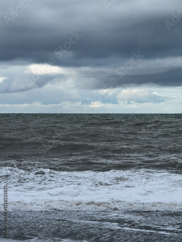 Obraz na płótnie Stormy ocean with dark clouds and rough waves w salonie