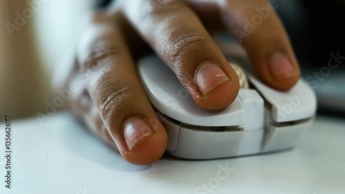 Close-Up of Hand Using White Computer Mouse, Close-up of a hand using a white computer mouse on a desk
