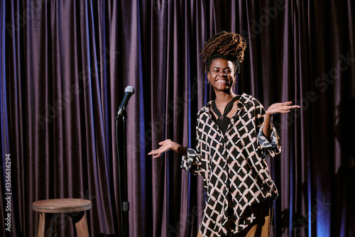 Εκτύπωση καμβά African American woman smiling and performing stand-up comedy on stage with microphone and stool visible