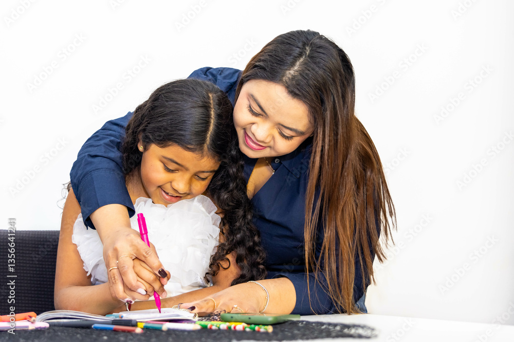 Fototapeta premium Mother helping daughter drawing with colored pencils at home
