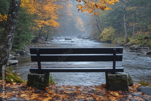 Autumn tranquility with a riverside bench in a serene forest landscape during misty weather