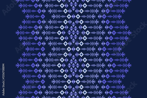 The Ikat woven fabric pattern is a traditional seamless blue and light blue zigzag patterned shawl or shawl on a dark blue background.